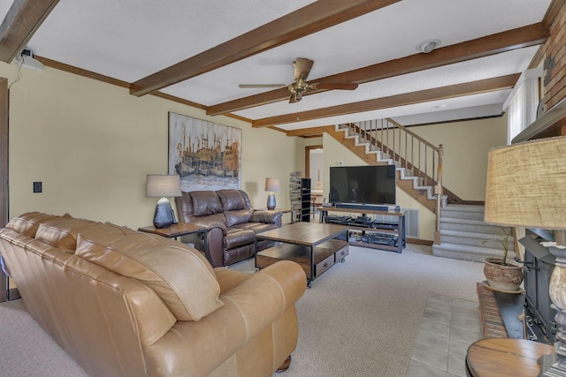 carpeted living room featuring a ceiling fan, stairway, beam ceiling, and ornamental molding