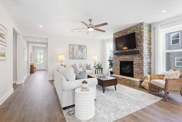 living area with recessed lighting, a fireplace, a ceiling fan, baseboards, and dark wood finished floors