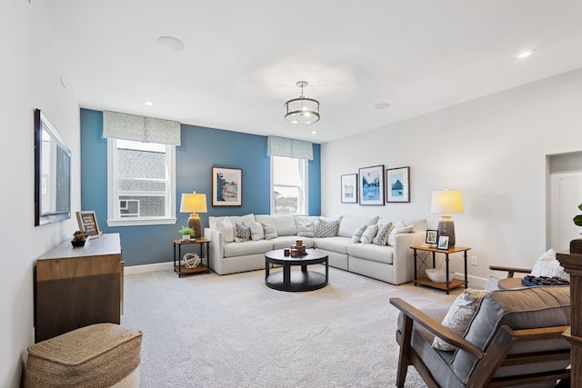 living area featuring light carpet, recessed lighting, and baseboards