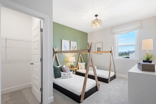 bedroom with light carpet and baseboards