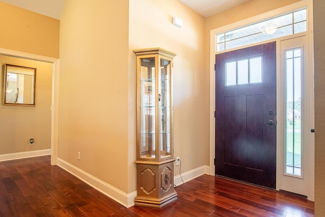 entryway with dark wood-style flooring and baseboards