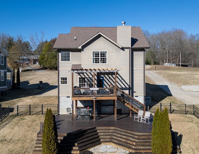 back of house featuring a fenced backyard, a chimney, a wooden deck, and a pergola