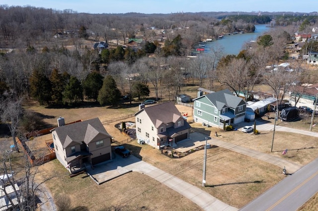 bird's eye view with a water view and a view of trees