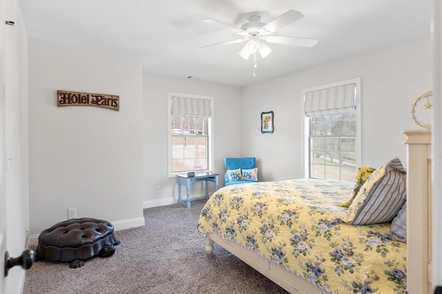 carpeted bedroom with baseboards and a ceiling fan