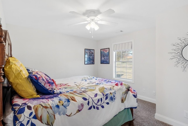 carpeted bedroom with baseboards and a ceiling fan