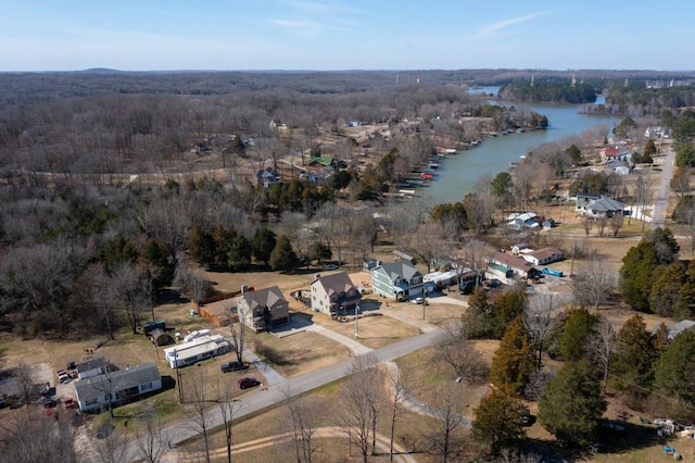 aerial view with a water view and a wooded view