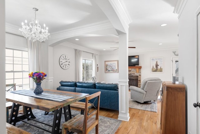 dining area with ornamental molding and a fireplace