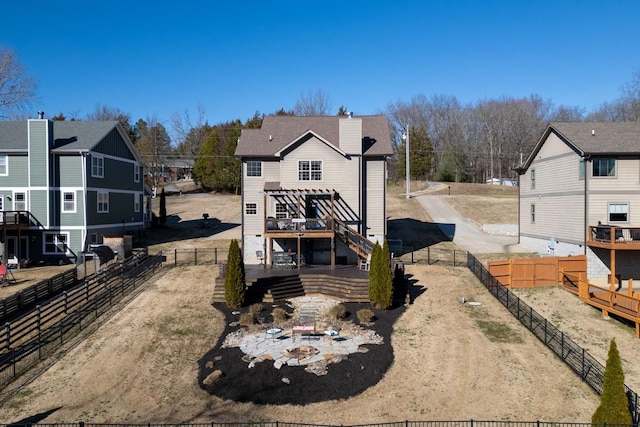 rear view of property featuring a patio, a fenced backyard, and a wooden deck