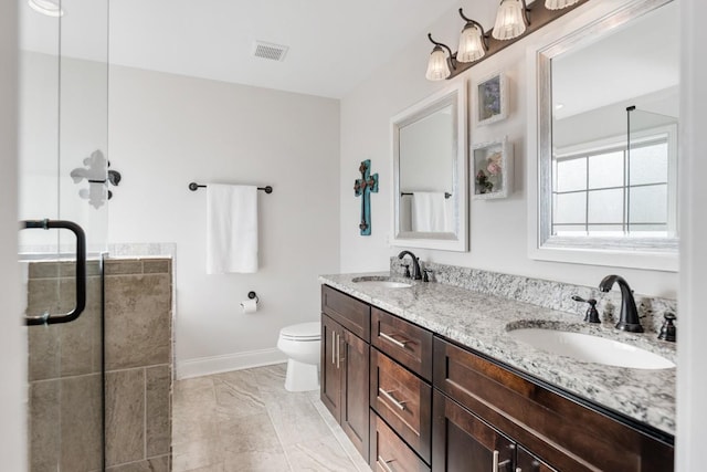 full bath featuring visible vents, a sink, toilet, and double vanity