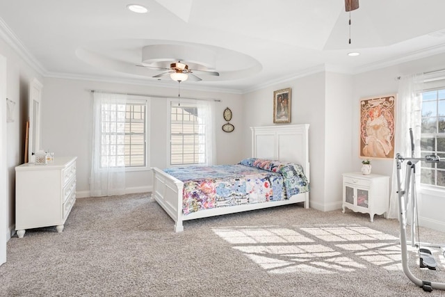 bedroom with baseboards, ornamental molding, a raised ceiling, and light colored carpet