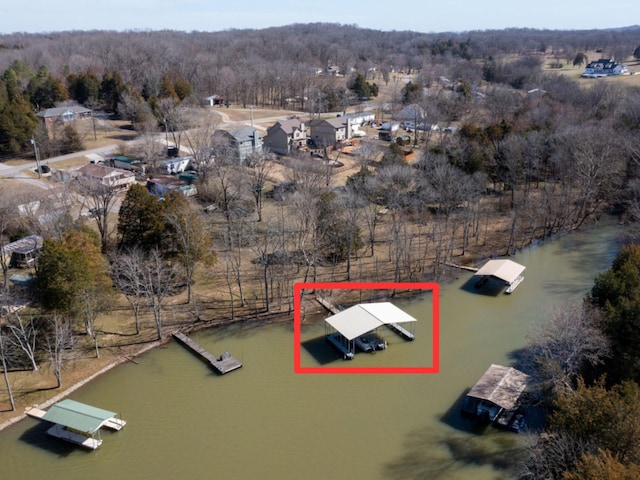 drone / aerial view featuring a water view and a wooded view