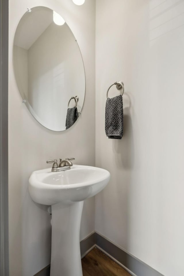 bathroom with wood finished floors and baseboards