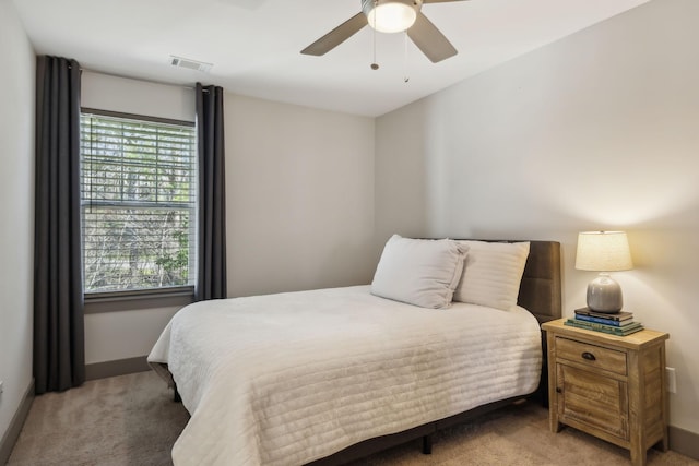 bedroom with ceiling fan, carpet floors, visible vents, and baseboards