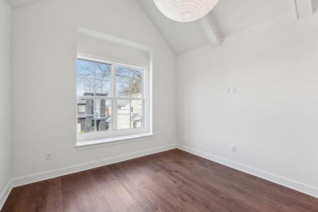 empty room with lofted ceiling with beams, baseboards, and dark wood-type flooring