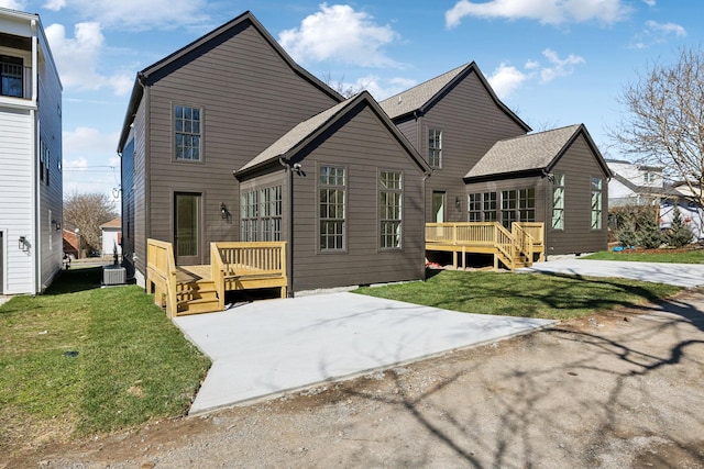 back of property featuring central AC, a lawn, and a wooden deck