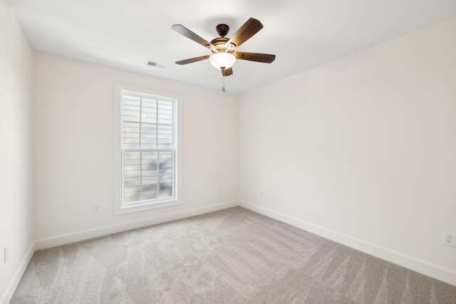 empty room featuring visible vents, baseboards, and carpet flooring