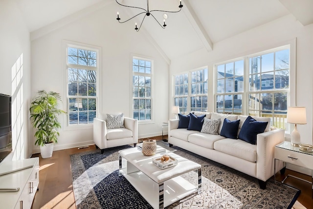 sunroom / solarium with a chandelier and vaulted ceiling with beams