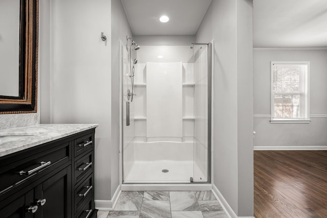 full bathroom featuring a shower stall, vanity, and baseboards