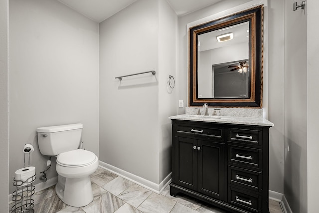 bathroom with toilet, visible vents, vanity, baseboards, and marble finish floor