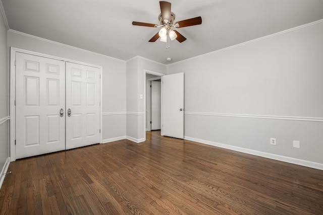 unfurnished bedroom with ornamental molding, a closet, wood finished floors, and baseboards