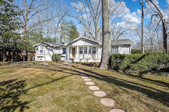 view of front of house with a porch and a front yard