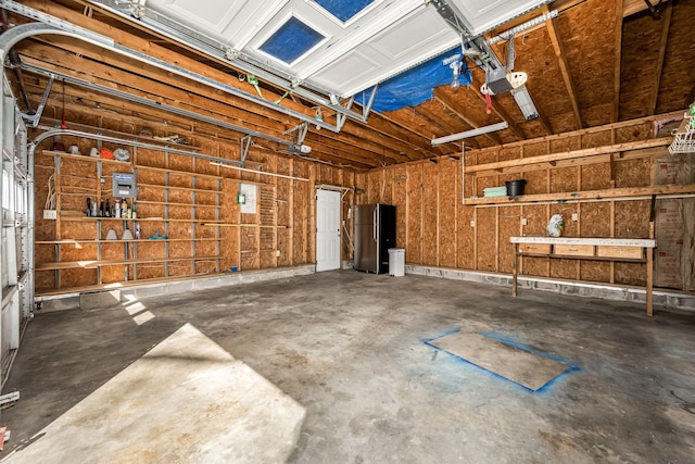 garage featuring a garage door opener and freestanding refrigerator