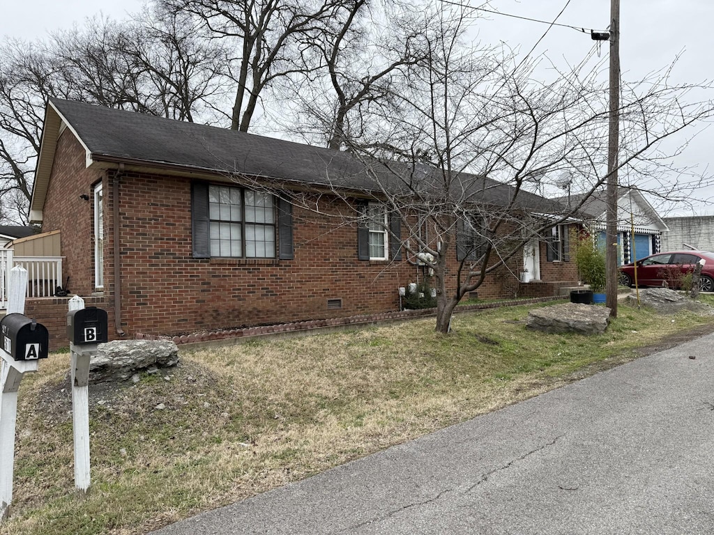 ranch-style house with brick siding and a front lawn