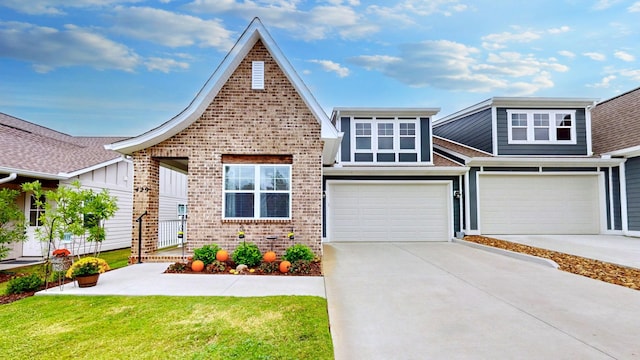 view of front of property with a garage, a front yard, brick siding, and driveway