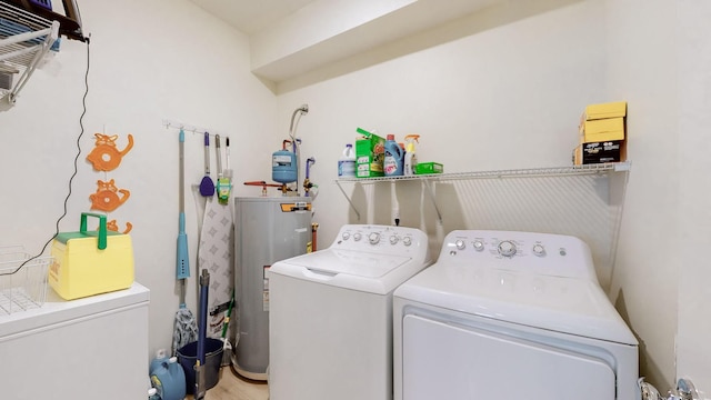 laundry area with laundry area, separate washer and dryer, and electric water heater