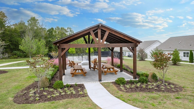 view of property's community with a yard, fence, a patio, and a gazebo