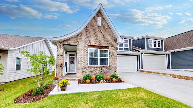 view of front of property featuring a front yard, brick siding, driveway, and an attached garage