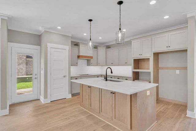919 Licinius Ln, Murfreesboro, TN 37128 - kitchen featuring an island with sink, light wood-style flooring, stovetop, a sink, and backsplash