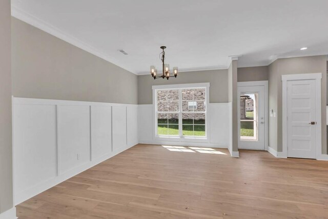 919 Licinius Ln, Murfreesboro, TN 37128 - unfurnished dining area with light wood-type flooring, a chandelier, crown molding, a wainscoted wall, and a decorative wall