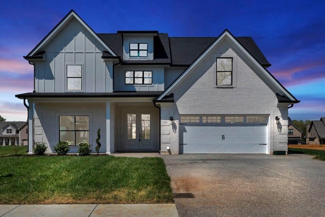 919 Licinius Ln, Murfreesboro, TN 37128 - view of front facade with board and batten siding, a garage, a yard, french doors, and driveway