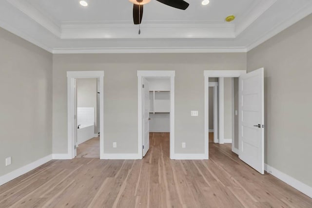 919 Licinius Ln, Murfreesboro, TN 37128 - unfurnished bedroom with a walk in closet, light wood finished floors, crown molding, and a raised ceiling