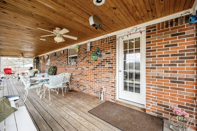 wooden terrace with a ceiling fan