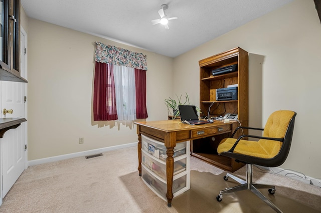 office space with carpet, visible vents, and baseboards