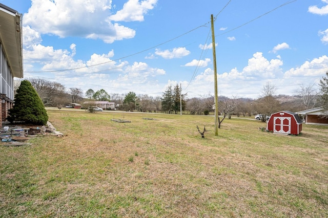 view of yard with a storage shed and an outbuilding