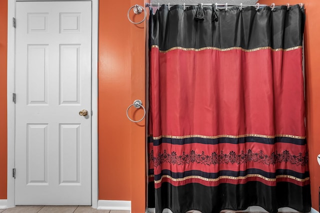 bathroom featuring curtained shower and tile patterned flooring