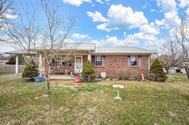 single story home featuring brick siding, metal roof, fence, a porch, and a front yard