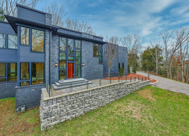 view of front of property with brick siding and a front lawn