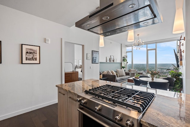 kitchen featuring stone counters, dark wood-type flooring, expansive windows, stainless steel gas stove, and ventilation hood