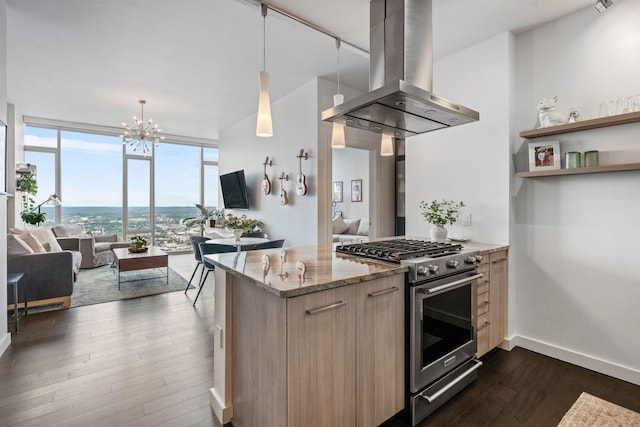 kitchen with stainless steel range, dark wood-type flooring, open floor plan, island range hood, and a wall of windows