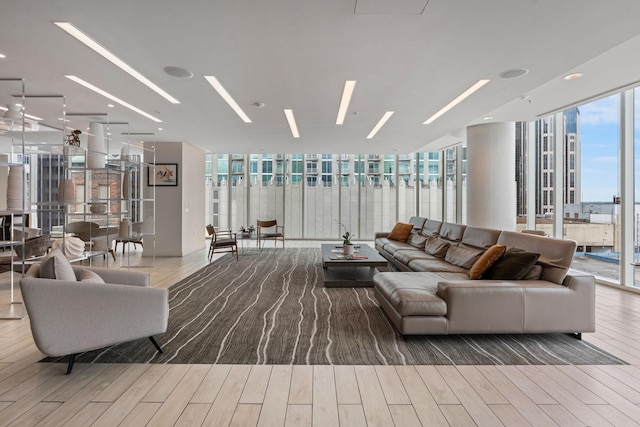 living area featuring a wall of windows and wood finished floors