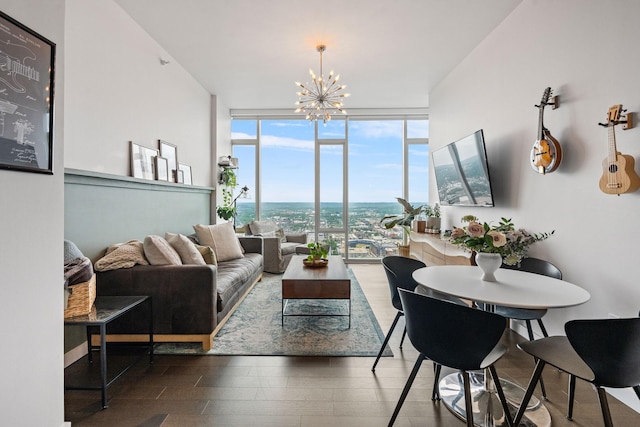 living area featuring a chandelier, a wall of windows, and wood finished floors