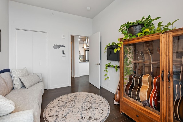 living area featuring dark wood finished floors and baseboards