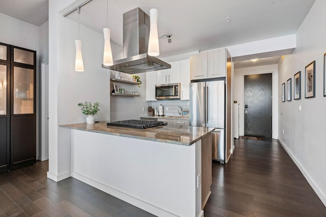 kitchen featuring dark wood-style flooring, island exhaust hood, appliances with stainless steel finishes, a sink, and light stone countertops