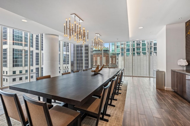 dining space with recessed lighting, an inviting chandelier, wood finished floors, and floor to ceiling windows