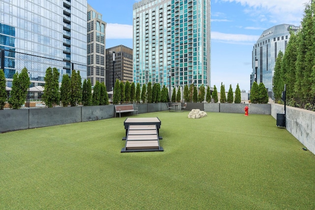 view of property's community with a view of city and fence