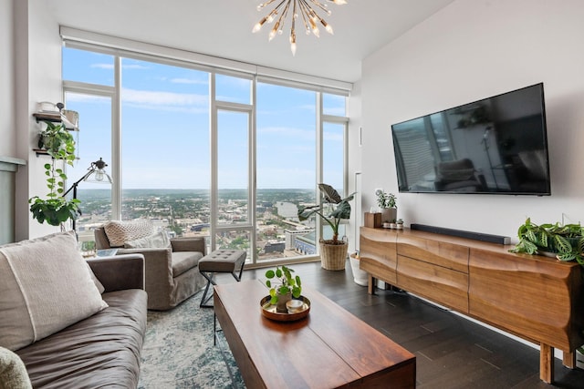 living room featuring an inviting chandelier, floor to ceiling windows, and wood finished floors